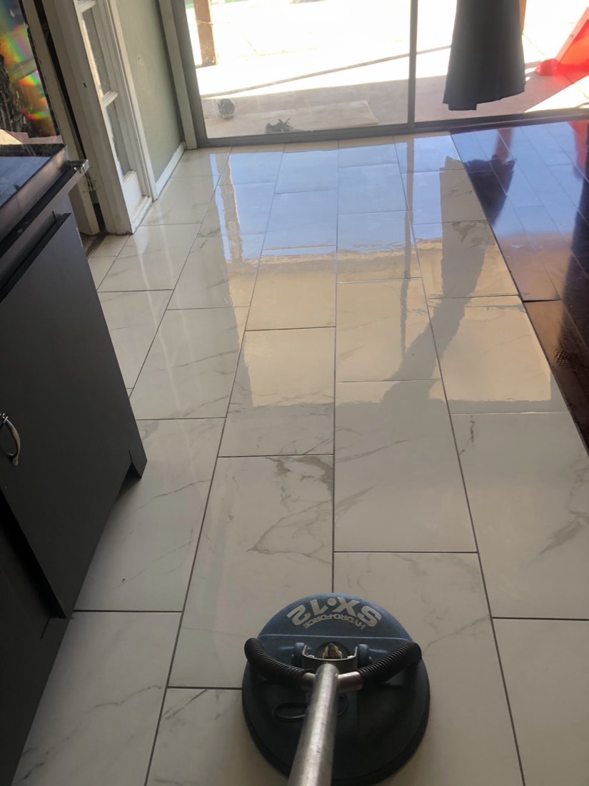 A tile floor with a cleaning machine at work